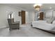 A main bedroom with a large window, hardwood doors, an armchair, and carpet at 5455 S 800 E, Zionsville, IN 46077