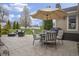 Outdoor stone patio featuring comfortable seating, a grill, and well-maintained landscaping at 5455 S 800 E, Zionsville, IN 46077