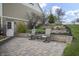 Charming patio with paved stones, two chairs, a table, and terraced landscaping leading to a backyard at 5455 S 800 E, Zionsville, IN 46077