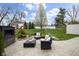 Outdoor patio space with comfortable seating, a fireplace, and a beautifully landscaped backyard at 5455 S 800 E, Zionsville, IN 46077