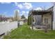 Beautifully landscaped backyard with a covered patio, string lights, and lush green lawn at 5455 S 800 E, Zionsville, IN 46077