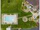 Aerial view of a pristine pool, surrounding patio, outdoor seating, and lush landscaping at 5455 S 800 E, Zionsville, IN 46077