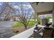 Charming covered porch featuring comfortable seating, a stylish rug, a ceiling fan, and a view of the landscaped yard at 5455 S 800 E, Zionsville, IN 46077