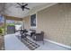 Inviting covered porch with a ceiling fan, comfortable seating, and a serene view, perfect for outdoor relaxation at 5455 S 800 E, Zionsville, IN 46077