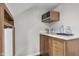 This charming wet bar features wood cabinets, a microwave, and plenty of storage for your drinks at 5455 S 800 E, Zionsville, IN 46077