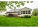 The backyard has a spacious lawn, patio, and lush landscaping, perfect for relaxing and entertaining guests at 558 Prince Dr, Greenwood, IN 46142