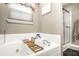 Relaxing bathroom featuring a soaking tub, window, and modern fixtures at 558 Prince Dr, Greenwood, IN 46142