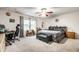Spacious bedroom with a large window offering ample natural light, neutral walls, and plush carpeting at 558 Prince Dr, Greenwood, IN 46142