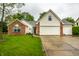 Charming brick and siding home featuring a well-manicured lawn and an attached two-car garage at 558 Prince Dr, Greenwood, IN 46142
