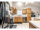 Well-equipped kitchen with oak cabinetry, black appliances, and durable countertops at 558 Prince Dr, Greenwood, IN 46142