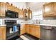 Functional kitchen with oak cabinets, black appliances, and ample counter space at 558 Prince Dr, Greenwood, IN 46142