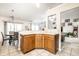 Bright kitchen with light countertops, wood cabinets, and open layout, seamlessly connecting to the dining and living areas at 558 Prince Dr, Greenwood, IN 46142