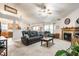 Cozy living room featuring a fireplace, ceiling fan, and plush seating at 558 Prince Dr, Greenwood, IN 46142