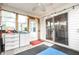 Bright sun room with multiple windows offering verdant outdoor views and easy access to the yard at 558 Prince Dr, Greenwood, IN 46142