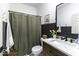 Modern bathroom with a shower curtain, dark wainscotting and a contemporary vanity at 561 Riviera Pl, Greenwood, IN 46143