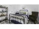 Inviting bedroom with an iron bed, neutral paint, and a reading nook at 561 Riviera Pl, Greenwood, IN 46143