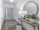 Bright entryway featuring a stylish console table, decorative lamps, and a round mirror, creating an inviting ambiance at 561 Riviera Pl, Greenwood, IN 46143