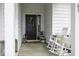 Inviting front porch with rocking chairs, decorative wreath, and charming decor perfect for relaxation and curb appeal at 561 Riviera Pl, Greenwood, IN 46143