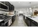 Well-equipped kitchen featuring sleek countertops, dark cabinetry, and a view into the dining area for easy entertaining at 561 Riviera Pl, Greenwood, IN 46143
