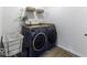 Convenient laundry room with side-by-side washer and dryer and built in countertop and shelving at 561 Riviera Pl, Greenwood, IN 46143