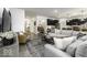 Open-concept living room showcasing stylish furniture, a large area rug, and seamless flow to the kitchen and dining area at 561 Riviera Pl, Greenwood, IN 46143