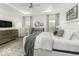 Bright main bedroom featuring a tray ceiling, soft natural light, and elegant décor at 561 Riviera Pl, Greenwood, IN 46143