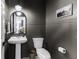 Chic powder room featuring stylish fixtures, wainscoting, and modern decor for a sophisticated and functional space at 561 Riviera Pl, Greenwood, IN 46143