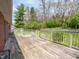 Spacious wooden back deck offering outdoor living and serene views of the lush, mature trees and landscaping at 575 Crestpoint Ln, Plainfield, IN 46168