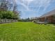 Spacious, well-maintained backyard featuring a lush lawn, brick home, and wooden deck, creating a peaceful outdoor retreat at 575 Crestpoint Ln, Plainfield, IN 46168