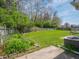 Expansive backyard with a lush lawn, a charming wooden fence, and an air conditioning unit at 575 Crestpoint Ln, Plainfield, IN 46168