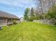 A well-kept lawn, wooden fence, and mature trees make this backyard a private outdoor retreat at 575 Crestpoint Ln, Plainfield, IN 46168