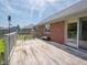 Wooden deck with railing offers space for outdoor seating and overlooks the yard and trees at 575 Crestpoint Ln, Plainfield, IN 46168