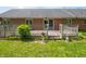 Grassy backyard featuring a wooden deck and brick house, perfect for outdoor relaxation and entertainment at 575 Crestpoint Ln, Plainfield, IN 46168
