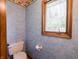 Cozy powder room with toilet and a bright window allowing natural light at 575 Crestpoint Ln, Plainfield, IN 46168