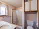 Cozy bathroom featuring a glass-enclosed shower, a vanity sink, toilet and storage cabinet at 575 Crestpoint Ln, Plainfield, IN 46168