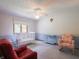 Bedroom featuring neutral walls, plush carpet, a crib, and a comfortable armchair at 575 Crestpoint Ln, Plainfield, IN 46168