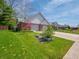 A beautiful single-Gathering home exhibiting a lush green lawn, brick exterior, and attached garage at 575 Crestpoint Ln, Plainfield, IN 46168