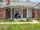 Inviting front porch with seating, brick facade, and well-maintained landscaping at 575 Crestpoint Ln, Plainfield, IN 46168