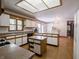 Spacious kitchen with skylight, island, white cabinets, and open flow to the dining area at 575 Crestpoint Ln, Plainfield, IN 46168