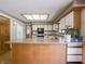 Well-lit kitchen with white cabinets, a skylight, and tile backsplash detail at 575 Crestpoint Ln, Plainfield, IN 46168