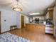 Open kitchen features wood floors, bright white cabinets, and a central island with bar seating at 575 Crestpoint Ln, Plainfield, IN 46168