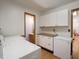 Laundry area with ample storage cabinets, countertop space and appliances at 575 Crestpoint Ln, Plainfield, IN 46168