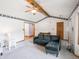 Open living room with beamed ceilings, neutral carpet, and access to other rooms at 575 Crestpoint Ln, Plainfield, IN 46168