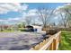 Wide backyard featuring driveway, car port, trailer and shed, all behind a wooden fence at 5831 Bar Del W Dr, Indianapolis, IN 46221