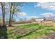 Expansive fenced backyard with a fire pit, offering privacy and space for recreation at 5831 Bar Del W Dr, Indianapolis, IN 46221