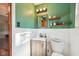Bathroom featuring green walls, a wood-tone vanity, and classic white tile at 5831 Bar Del W Dr, Indianapolis, IN 46221