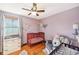 Charming Bedroom featuring a red crib, hardwood floors, and butterfly wall decor at 5831 Bar Del W Dr, Indianapolis, IN 46221