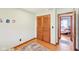 Bright bedroom featuring a built-in wardrobe, hardwood floors, and light green walls at 5831 Bar Del W Dr, Indianapolis, IN 46221