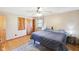 Bedroom with hardwood floors, double door closet, and a side table with lamp at 5831 Bar Del W Dr, Indianapolis, IN 46221