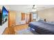 Well lit bedroom with hardwood floors, double door closet, and mounted television at 5831 Bar Del W Dr, Indianapolis, IN 46221